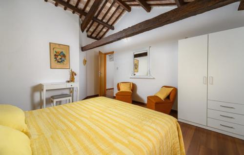 a bedroom with a bed and two chairs and a fireplace at Villa Santina near Poreč in Radovani
