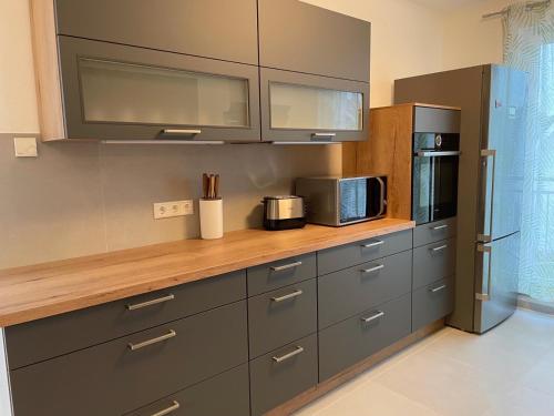 a kitchen with a counter with a microwave and a refrigerator at Helle Wohnung mit Balkon 120qm, 4Zimmer in Dortmund