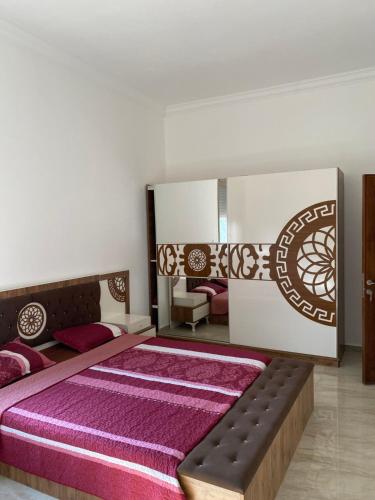 a bedroom with a large bed and a mirror at Old Jericho homestay in Jericho