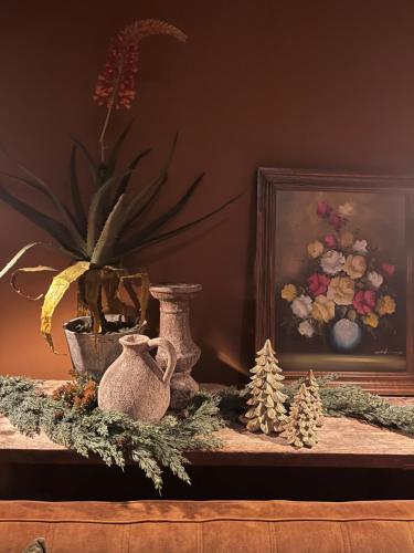 a table with a vase and christmas decorations on it at Sfeervol familielandhuis in de groene Kempen in Baarle-Hertog