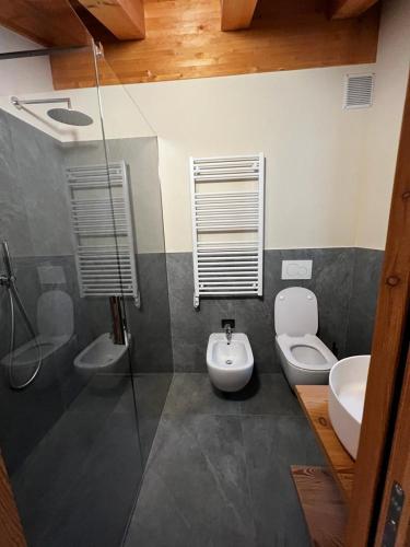 a bathroom with a toilet and a sink at YETI Design mountain apartments in Valdidentro