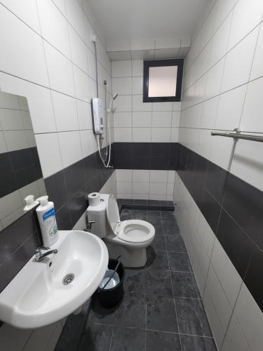 a bathroom with a sink and a toilet at Praicon Tower - Premium Suite in Butterworth
