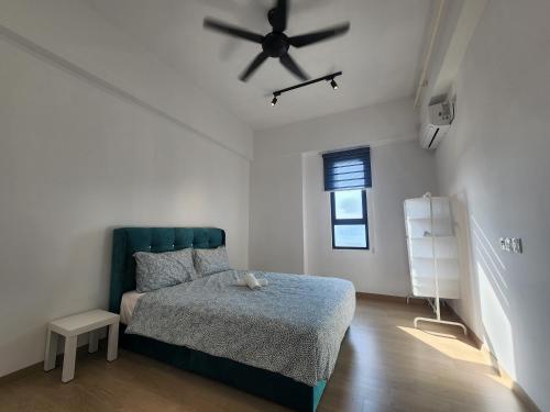 a bedroom with a bed and a ceiling fan at Praicon Tower - Premium Suite in Butterworth