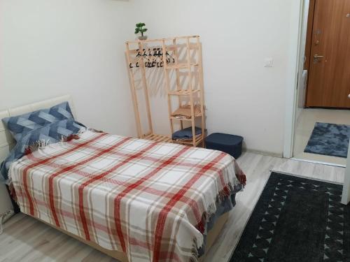a bedroom with a bed with a plaid blanket at Private Room in Istanbul #9 in Istanbul