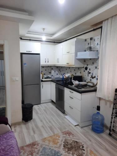 a kitchen with white cabinets and a refrigerator at Private Room in Istanbul #9 in Istanbul