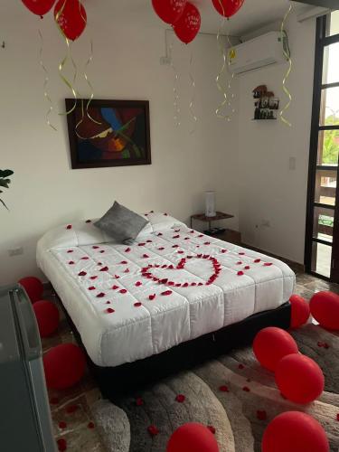 a bedroom with a bed with red hearts on it at HOTEL EMPRESARIAL Arcoiris de mi llano in Paz de Ariporo