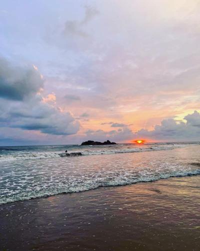 a sunset on a beach with the ocean at Sriyan Villa in Beruwala