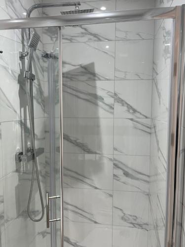 a shower with a glass door in a bathroom at La Vie - Entire Apartment - Next to Central District Elizabeth line Tube Station - Near Central London & Wembley in Ealing