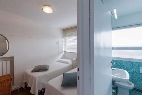a small room with two beds and a sink at [Duca d'Aosta - il soffio del mare] in Viareggio