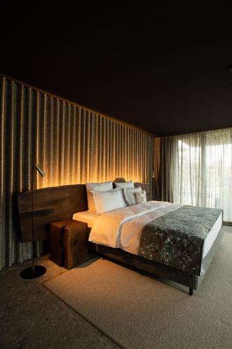a bedroom with a large bed and a window at HAY boutique hotel & SPA by Edem Family in Bukovel