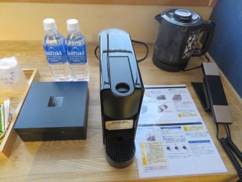 a cell phone on a table next to bottles of water at Kashoutei Hanaya in Noboribetsu