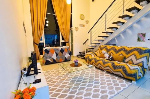a living room with a couch and a staircase at Elegant 5STAR Resort Suite Mid Valley KL Sunway by Stayz Suites with Shopping Complex in Kuala Lumpur
