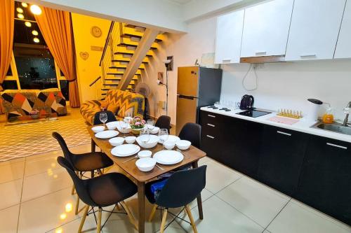 a kitchen with a table and chairs in a kitchen at Elegant 5STAR Resort Suite Mid Valley KL Sunway by Stayz Suites with Shopping Complex in Kuala Lumpur