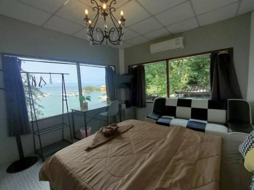 a bedroom with a bed and a large window at I-Talay Zone Sea in Ko Samed