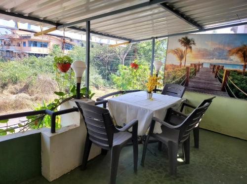 a table and chairs on a patio with a view of a staircase at Bella Villa Luxury Stay in Panaji