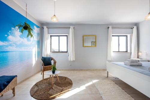 Un dormitorio con una cama, una mesa y una silla. en Bay View Townhouse, en Salema