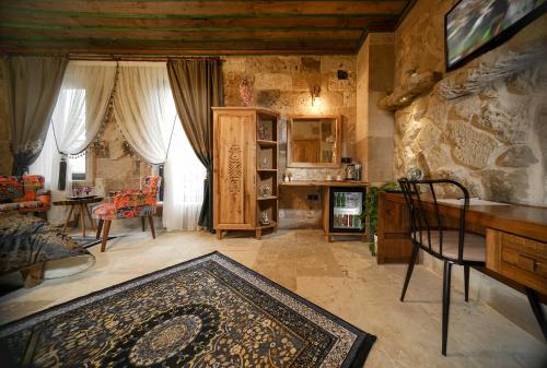 a living room with a couch and a table at Serene Premium Stone House in Nevsehir