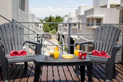 een tafel met eten en drinken op een balkon bij Apart Porto del Sol by CPH in Villa Carlos Paz