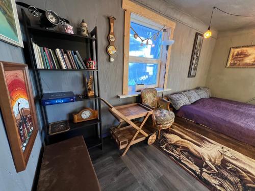a bedroom with a purple bed and a window at Private Farm Jakuzzi Sauna in the forest in Talsi