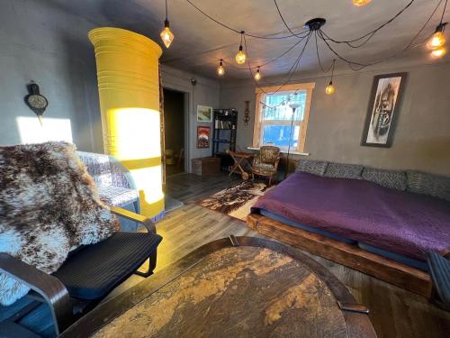 a bedroom with a bed and a chair in it at Private Farm Jakuzzi Sauna in the forest in Talsi