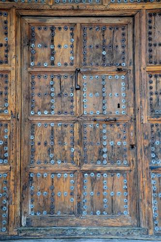 an old wooden door with metal studs on it at Hotel Cigarral el Bosque in Toledo