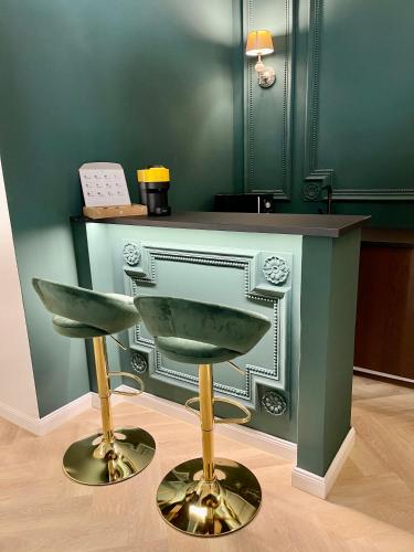 a bar stool and a counter in a room at TOP Luxury Suites in Budapest
