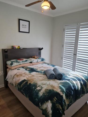 a bedroom with a bed with blue pillows on it at 4 Main Sail Port St Francis in St Francis Bay