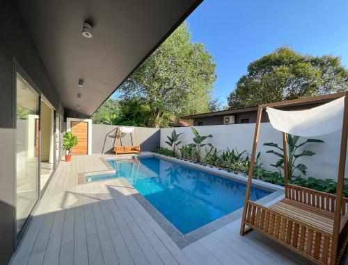 a swimming pool in the backyard of a house at Looma Private Pool Villas in Pantai Cenang