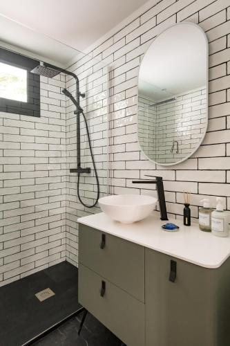 a bathroom with a sink and a mirror at Eva Boutique Apartment in Funchal