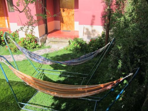 a hammock in front of a house at Kurumi Hostel in Cusco