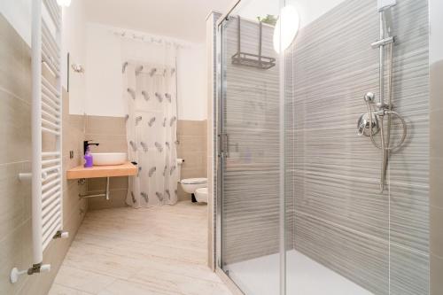 a bathroom with a shower and a toilet and a sink at Il Ciclamino in Tarquinia