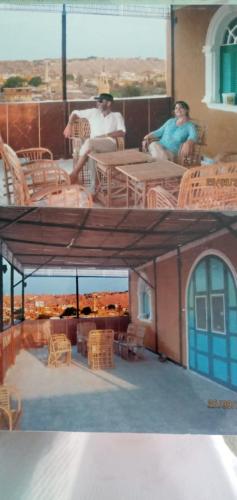 dos personas sentadas en mesas en el techo de un edificio en جزيره سهيل en El Cairo