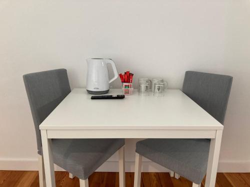 a white table with two chairs and a blender on it at Museum House in Funchal