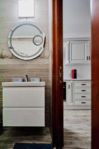 a bathroom with a sink and a mirror at Galiceanu Apart Deluxe in Bistriţa