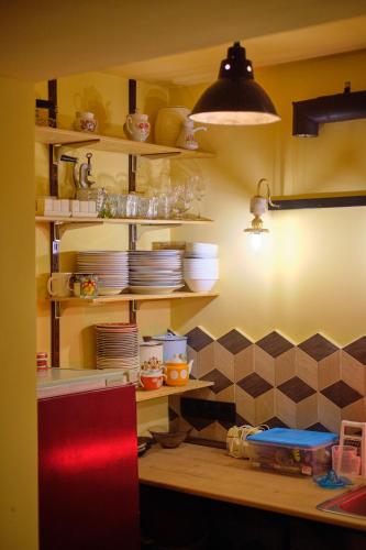 a kitchen with a counter with plates on shelves at Kotun Gyumri in Gyumri