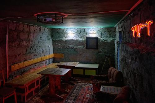 a dark room with a table and a chair in a room at Kotun Gyumri in Gyumri