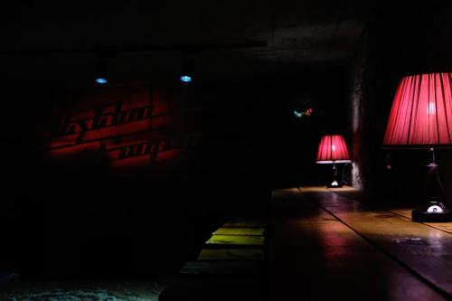 a dark room with two red lamps in the dark at Kotun Gyumri in Gyumri