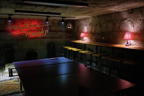 a dark room with a table and some chairs at Kotun Gyumri in Gyumri