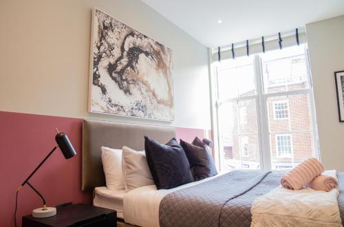 a bedroom with a bed and a large window at Luxury 2 Bedroom Apartment Near Train Station in Welwyn Garden City