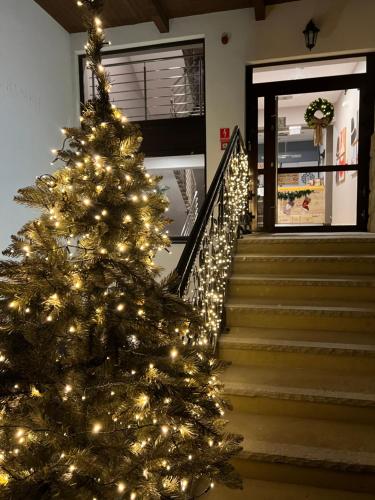 a christmas tree on the stairs of a house at Hotel Nosal Ski & Wine in Zakopane