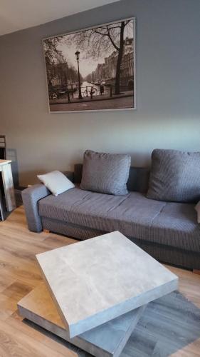 a living room with a couch and a table at Flensburg Strandnah in Flensburg