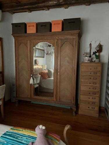 a bedroom with a large wooden cabinet with a mirror at Casa H6 in Maipú