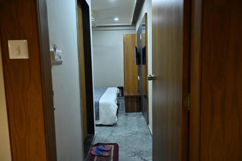 a hallway to a bedroom with a bed in a room at HOTEL SURY VILLA in Ahmedabad