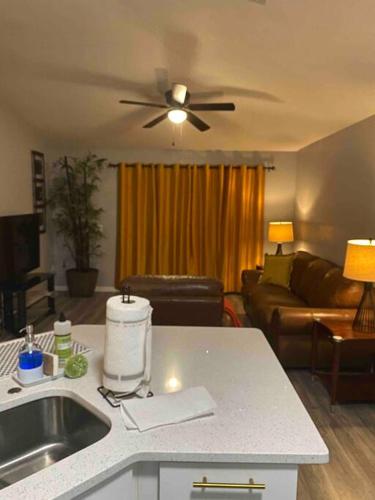 a kitchen and living room with a ceiling fan at Florida Suburban Oasis ~ Lk Mary/Sanford Florida! in Sanford