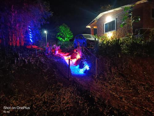 a garden lit up at night with christmas lights at The Royal Ascot Holiday Home in Alibaug