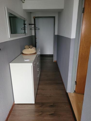 a hallway with a white cabinet and a door at Am Möhnesee in Warstein