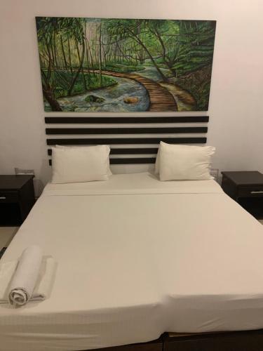 Postel nebo postele na pokoji v ubytování Sunrise Palace Negombo