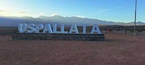 a sign that says us palala in the desert at Departamento uspallata in Uspallata