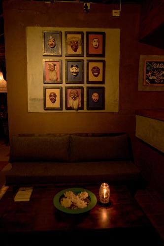 a living room with a couch and a plate of food on a table at Gaga Bees Yala in Tissamaharama