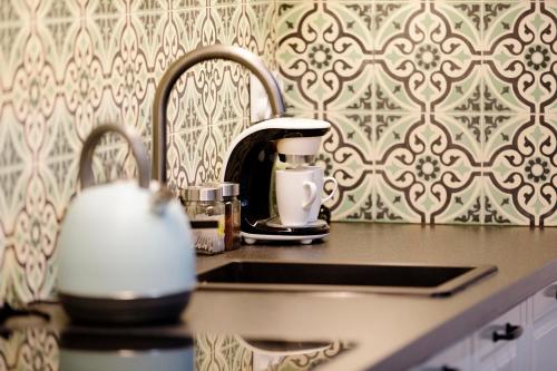 a kitchen counter with a coffee maker on a sink at Na zielonym Widoku in Wrocław